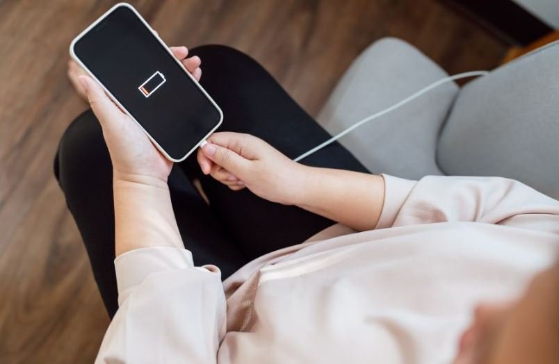 person charging an iPhone